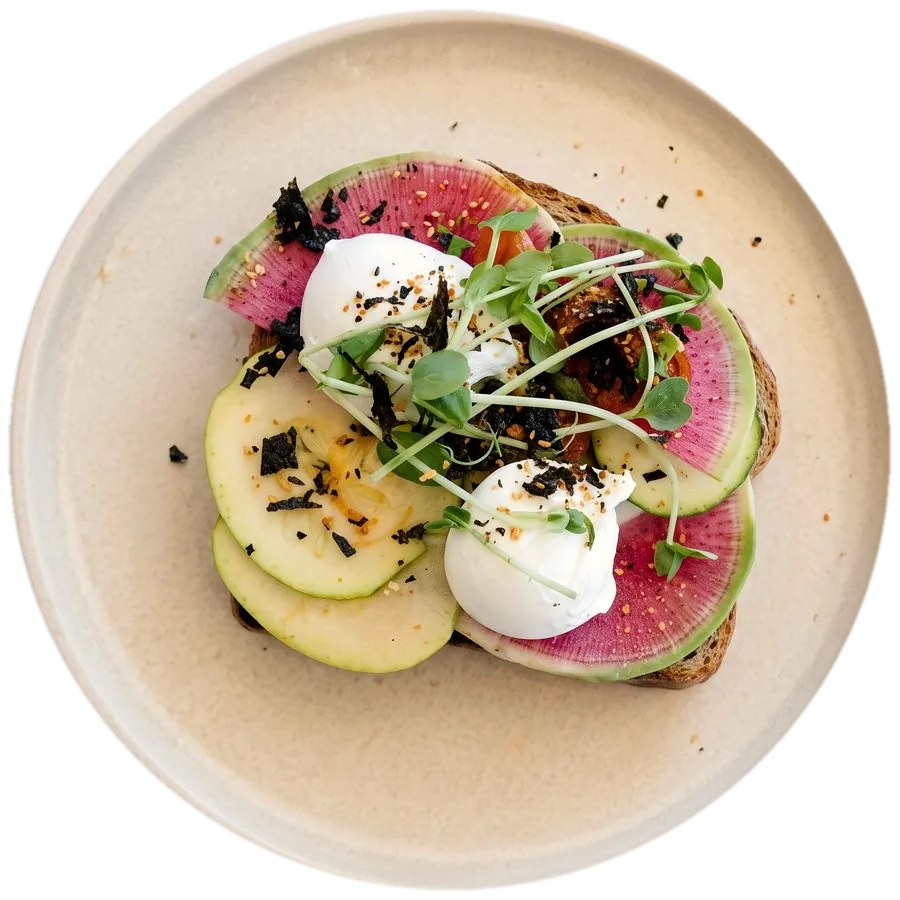 Avo on toast with zucchini ribbons and poached eggs, from above